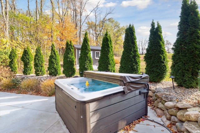 exterior space featuring a jacuzzi and concrete flooring