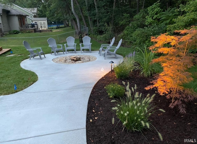 exterior space featuring a trampoline and a fire pit