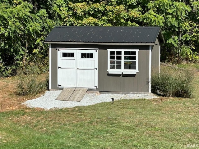 view of outdoor structure with a lawn