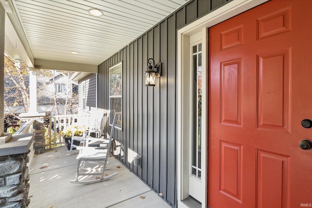 313 Tiger Ct, New Carlisle, IN 46552 - entrance to property with board and batten siding and a porch