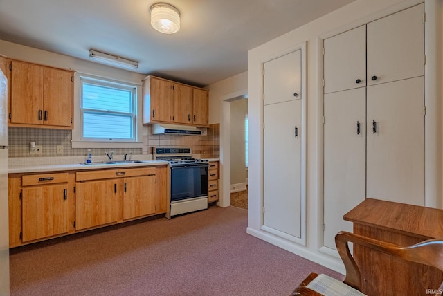 kitchen featuring light carpet, decorative backsplash, sink, and white range