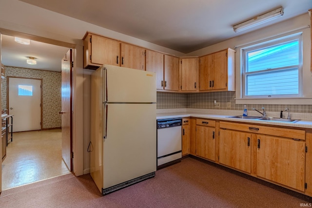 kitchen featuring tasteful backsplash, sink, and white appliances