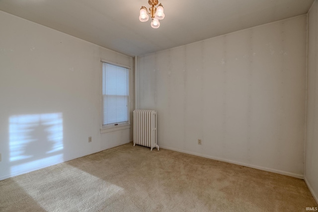 unfurnished room with a notable chandelier, light colored carpet, radiator, and a wealth of natural light