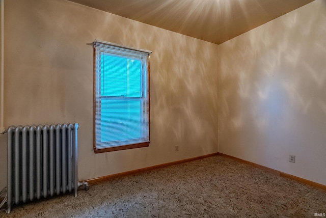 carpeted spare room with radiator