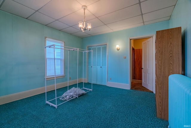 interior space with a paneled ceiling and a notable chandelier