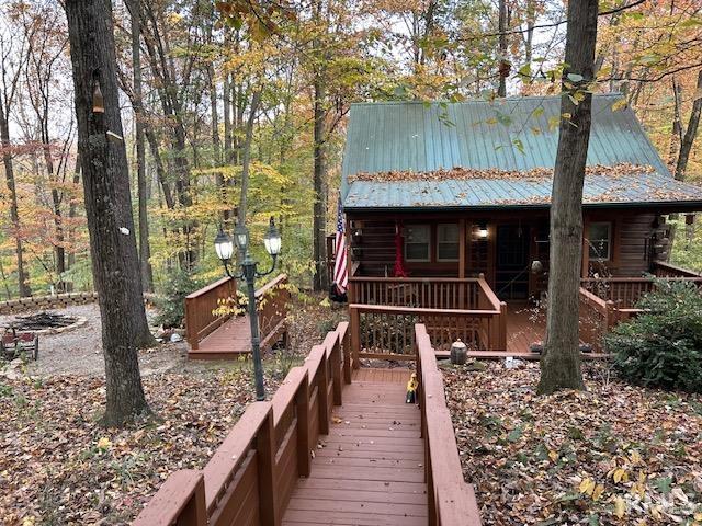 3210 Cedar Gap Ln, Birdseye, IN 47513 - rear view of house with log siding, metal roof, and a deck