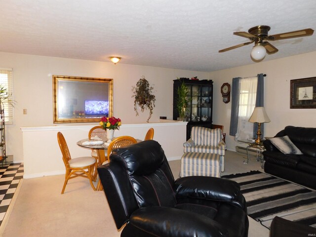 living room featuring a wealth of natural light, light colored carpet, and ceiling fan