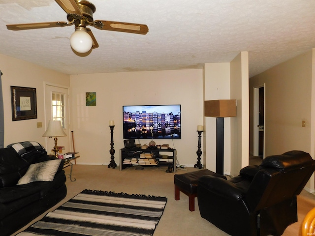 living room with ceiling fan, a textured ceiling, and carpet floors