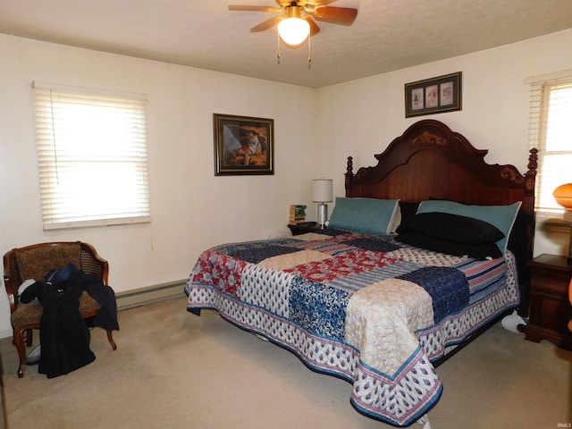 bedroom featuring a baseboard radiator, ceiling fan, carpet flooring, and multiple windows