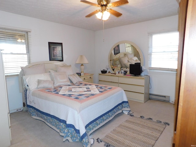 bedroom with light colored carpet, a baseboard radiator, and ceiling fan