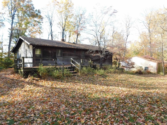 view of property exterior with a wooden deck