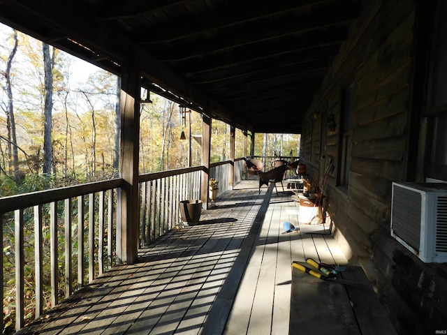 wooden deck featuring cooling unit