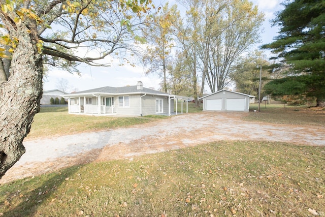 ranch-style house featuring a front yard, an outbuilding, and a garage