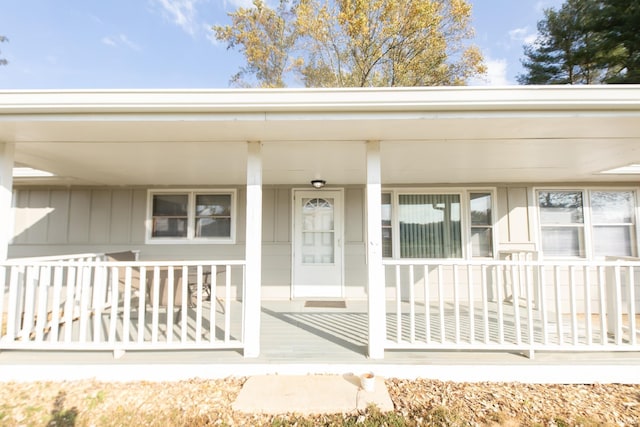 view of exterior entry with a porch