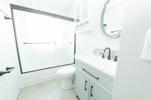 full bathroom featuring vanity, toilet, and shower / bath combination with glass door