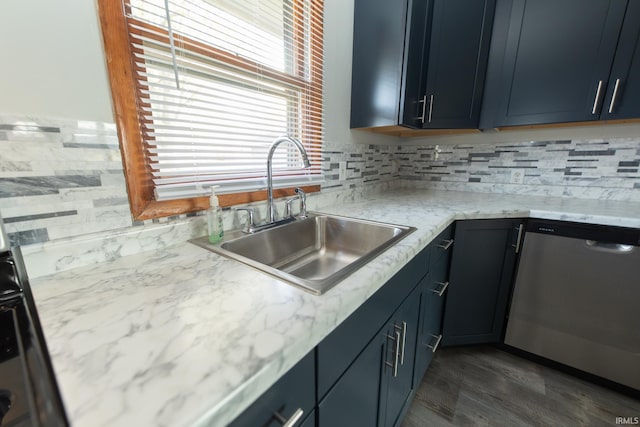 kitchen with light stone countertops, sink, dark hardwood / wood-style flooring, stainless steel dishwasher, and decorative backsplash