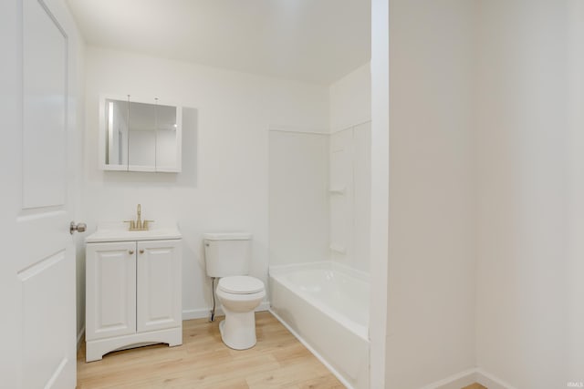 bathroom with vanity, a bathtub, toilet, and wood-type flooring