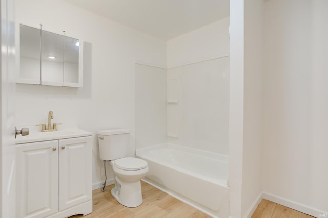 full bathroom with washtub / shower combination, vanity, wood-type flooring, and toilet