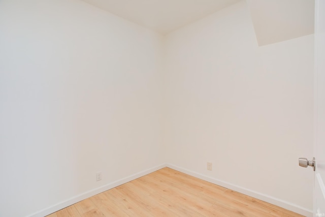 empty room with hardwood / wood-style flooring