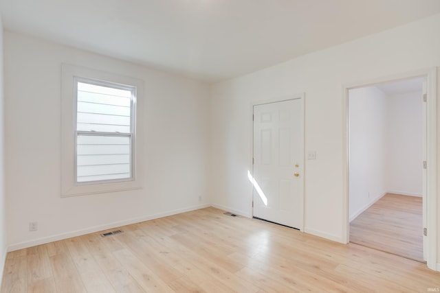 unfurnished room with light wood-type flooring