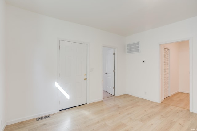 spare room featuring light wood-type flooring