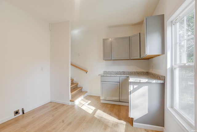 kitchen featuring gray cabinetry and light hardwood / wood-style floors