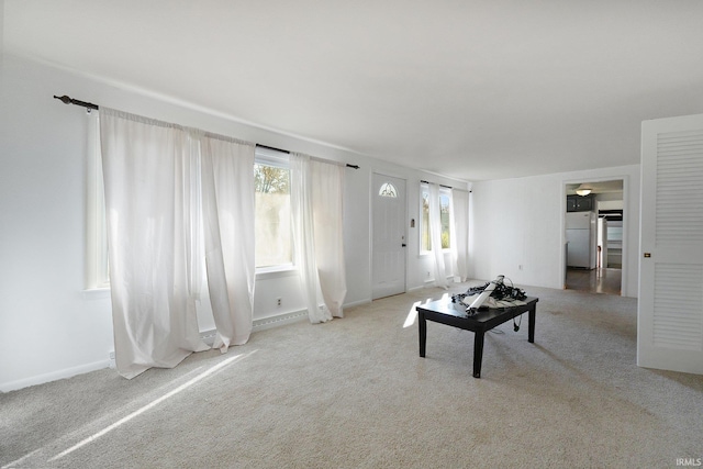 unfurnished living room with light colored carpet