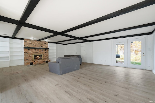 unfurnished living room with beam ceiling and light hardwood / wood-style floors