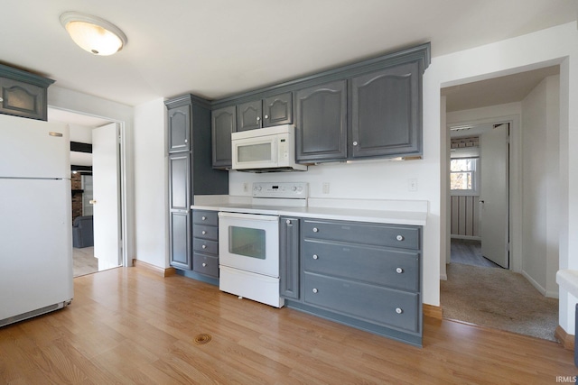 kitchen featuring white appliances and light wood-type flooring