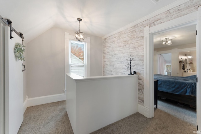 interior space featuring lofted ceiling, a barn door, and light colored carpet