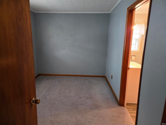 empty room with ornamental molding, washer / clothes dryer, and light carpet