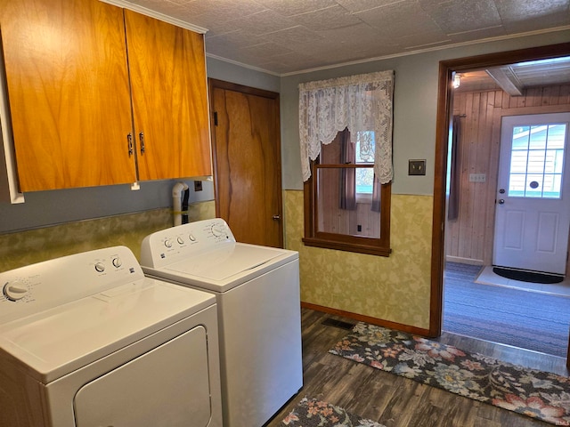 laundry room featuring cabinets, ornamental molding, dark hardwood / wood-style flooring, and separate washer and dryer