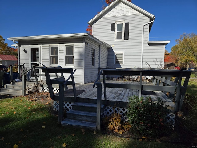 back of property featuring a deck