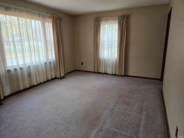 spare room featuring light colored carpet