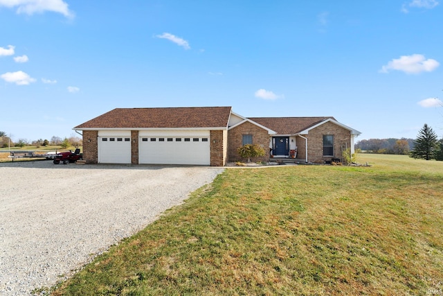 single story home featuring a front lawn and a garage