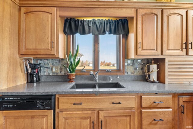 kitchen with dishwashing machine, tasteful backsplash, and sink