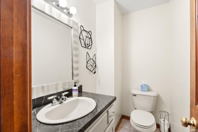 bathroom with vanity, toilet, and tile patterned flooring