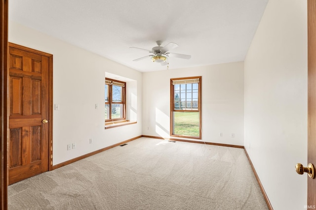 carpeted empty room featuring ceiling fan