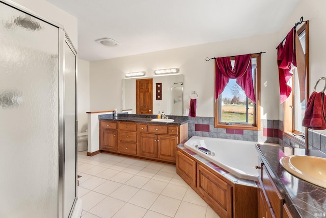 full bathroom featuring vanity, plus walk in shower, toilet, and tile patterned flooring