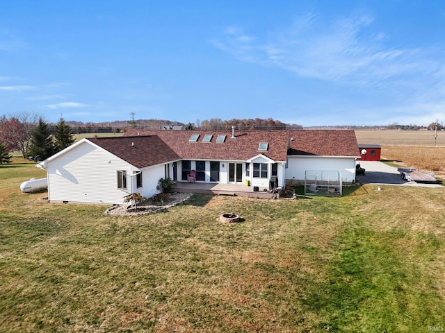 back of house with a patio and a lawn