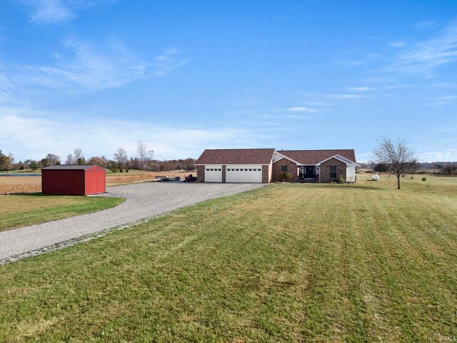 single story home featuring an outbuilding, a front lawn, and a garage