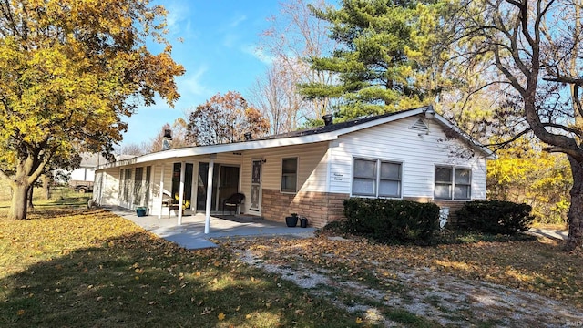 back of house featuring a patio and a yard