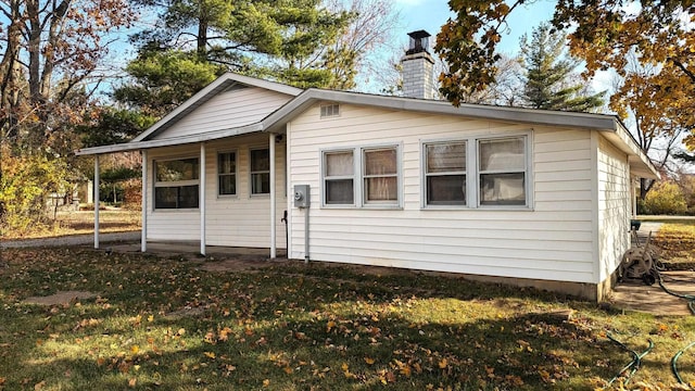 rear view of property with a yard