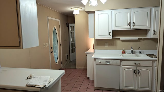 kitchen with white cabinetry, dishwasher, sink, and dark tile patterned floors