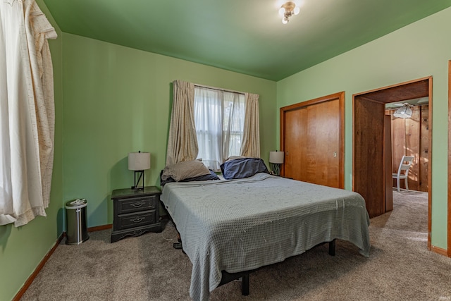 bedroom featuring baseboards and carpet flooring
