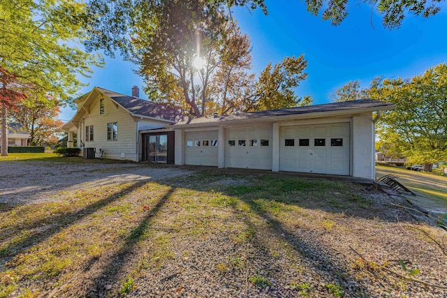garage with central AC and driveway