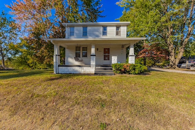 view of front of property with covered porch and a front lawn