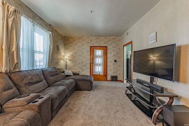 carpeted living area with wallpapered walls