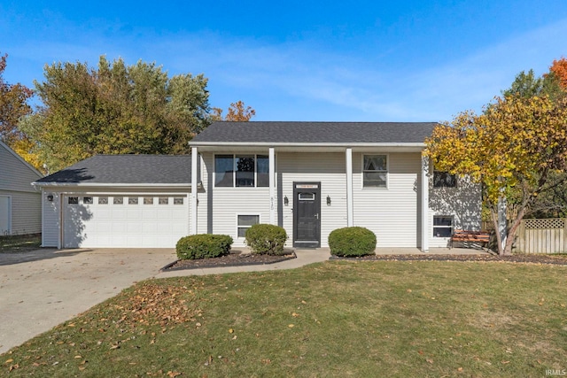 bi-level home featuring a front lawn and a garage