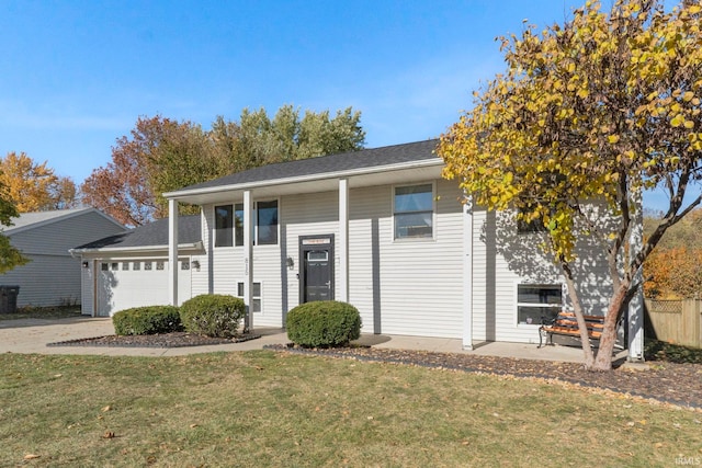 split foyer home featuring a front lawn and a garage